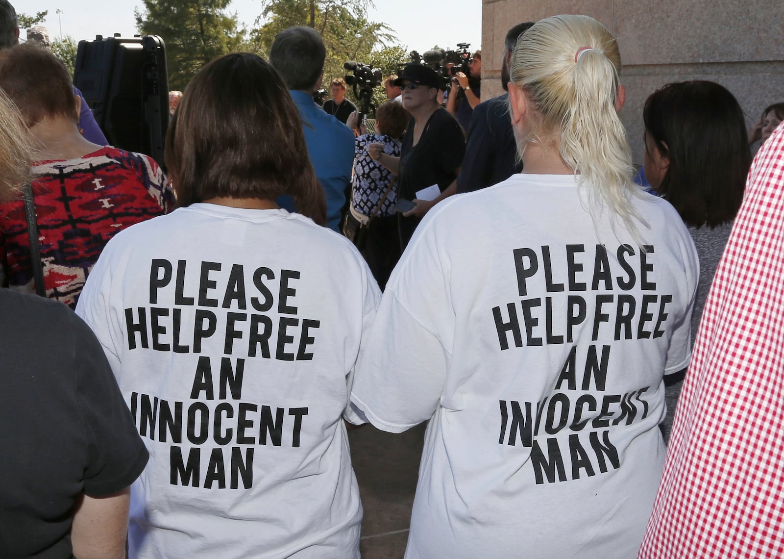 Ericka Glossip-Hodge, left, daughter of Richard Glossip, and Billie Jo Ogden Boyiddle, right, Richard Glossip's sister, listen during a rally to stop the execution of Richard Glossip, in Oklahoma City, Tuesday, Sept. 15, 2015. (AP Photo/Sue Ogrocki, File)