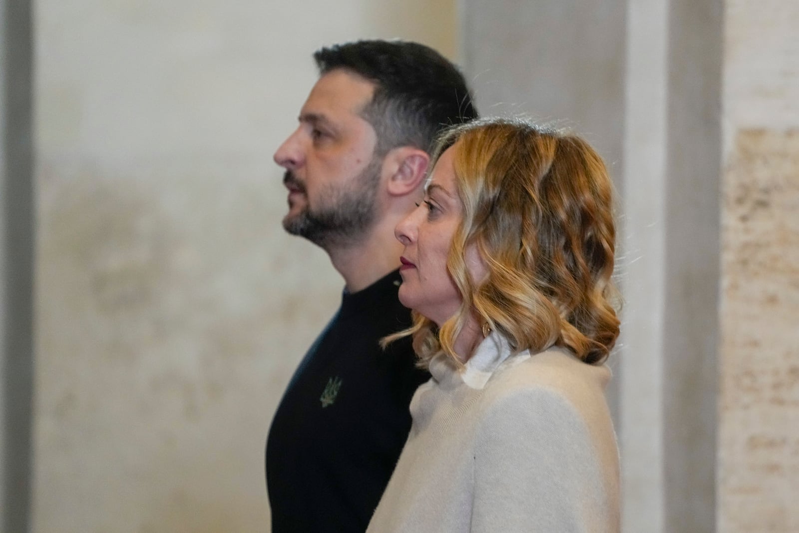 Ukrainian President Volodymyr Zelenskyy, left, is welcomed by Italian Premier Giorgia Meloni at Chigi Palace government headquarters in Rome, Thursday, Jan. 9, 2025, as he arrives for talks. (AP Photo/Gregorio Borgia)