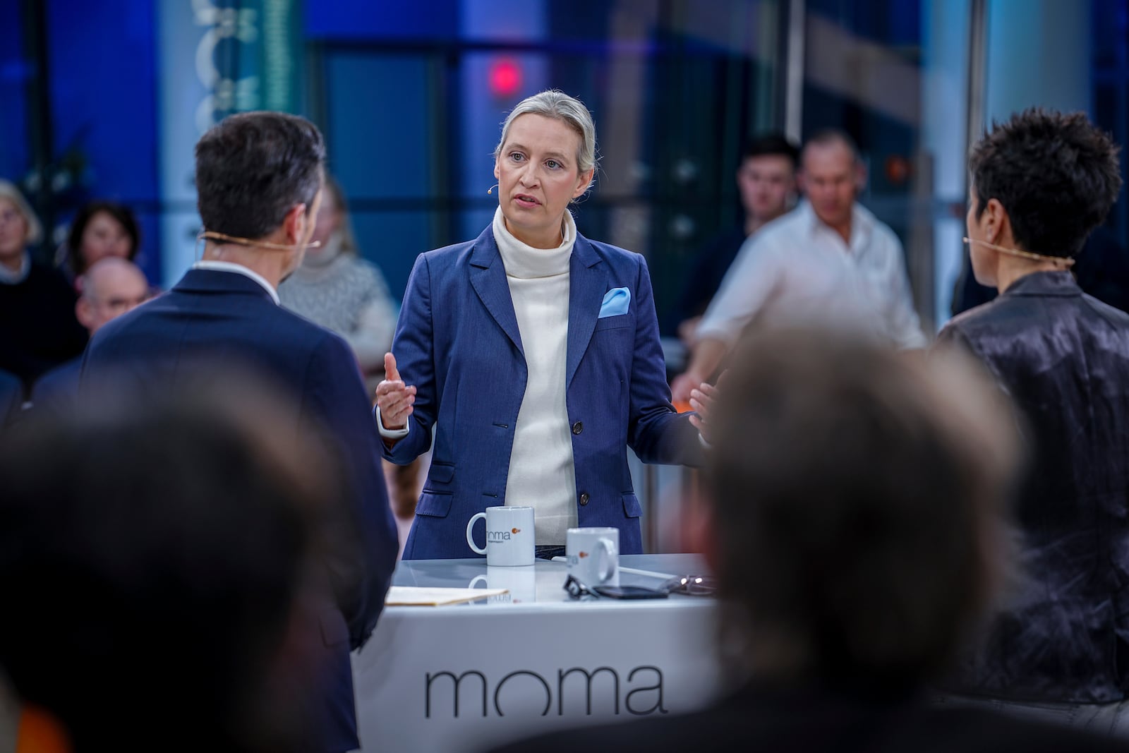 Candidate for chancellor and leader of the AfD (Alternative for Germany) parliamentary group, Alice Weidel talks to presenters Andreas Wunn and Dunja Hayali, right, in an interview on the ZDF morning show "moma vor der Wahl", in Berlin, Friday Feb. 21, 2025. (Kay Nietfeld/dpa via AP)