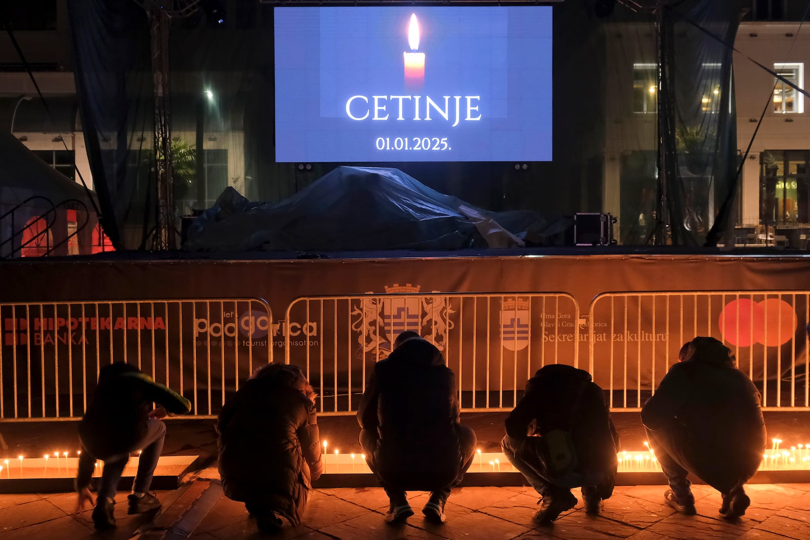 People light candles for the victims of the yesterdays, shooting rampage in Cetinje, in Podogrica, Montenegro, Thursday, Jan. 2, 2025. (AP Photo/Risto Bozovic)