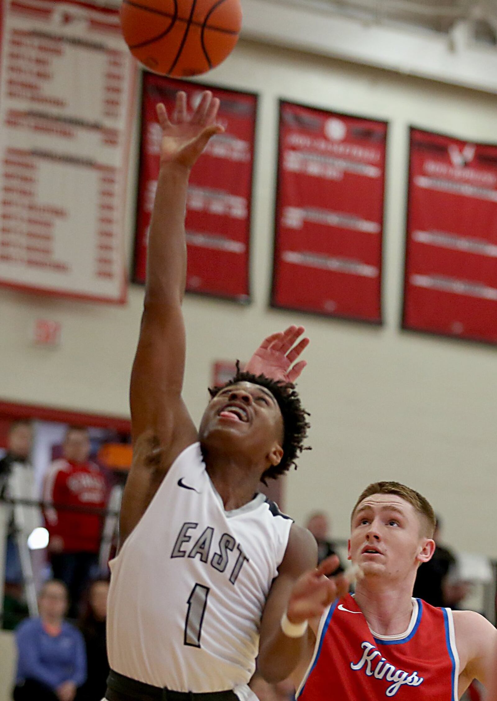 Lakota East guard Jalen Peck gets past Kings guard Clay Spivey and takes a shot during Wednesday night’s Division I sectional game at Lakota West. CONTRIBUTED PHOTO BY E.L. HUBBARD