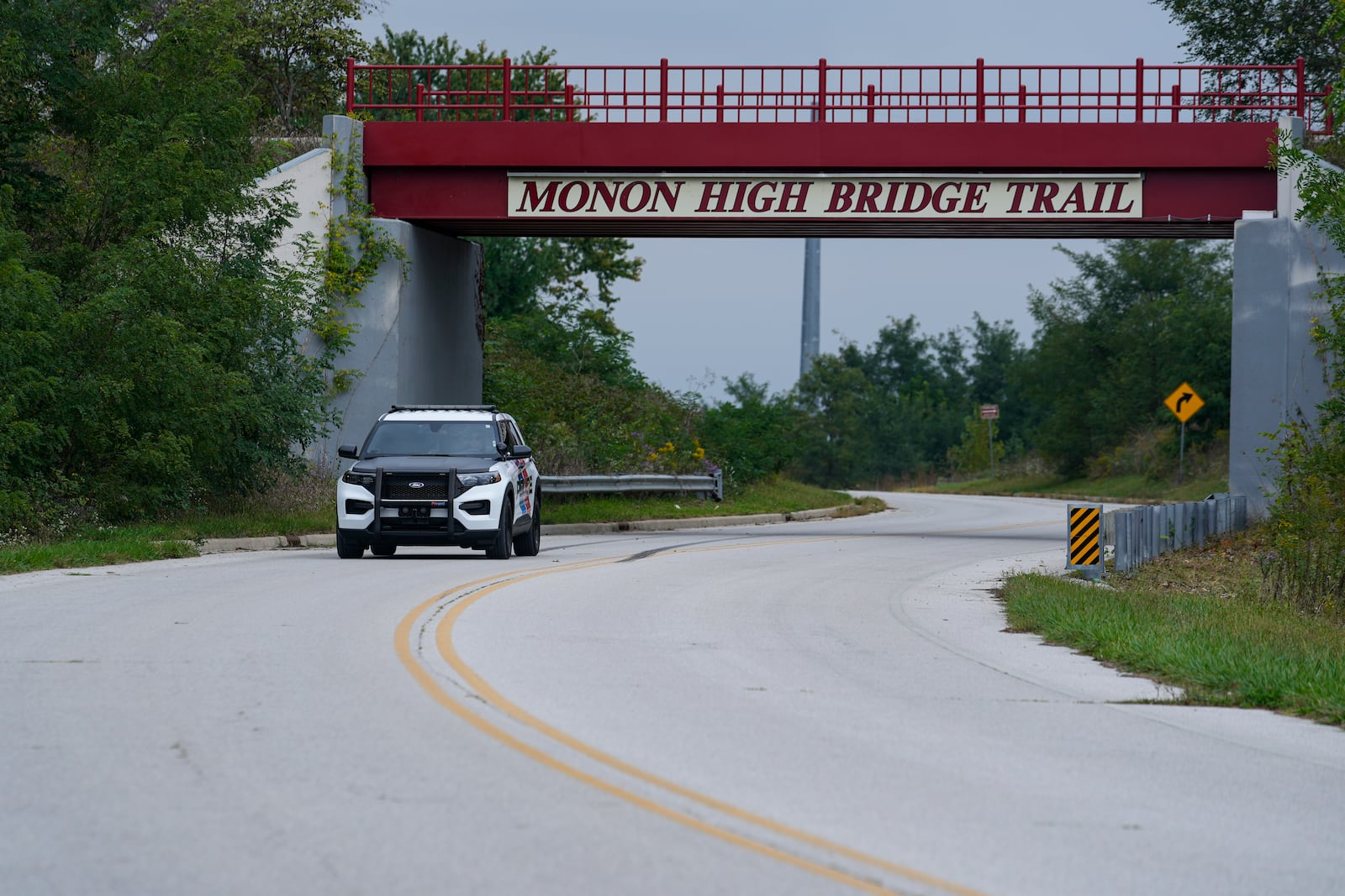 A Delphi Police Department vehicle drives under the Monon High Bridge Tail in Delphi, Ind., Tuesday, Oct. 1, 2024. (AP Photo/Michael Conroy)