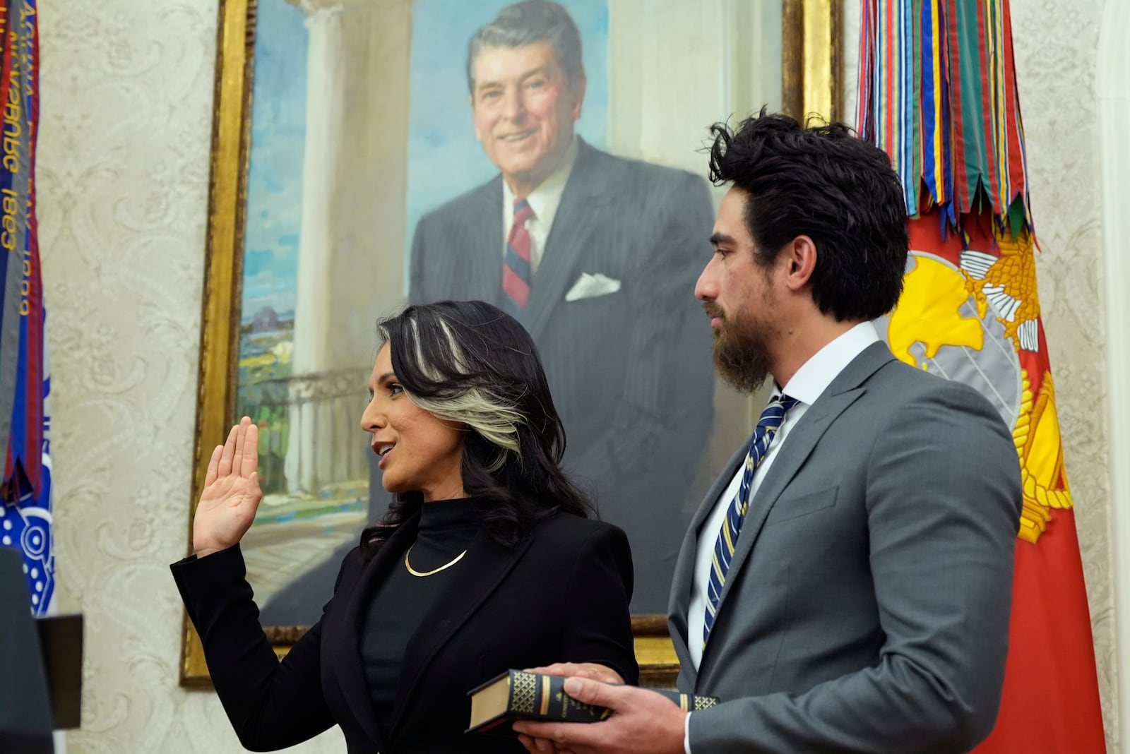 Attorney General Pam Bondi swears in Tulsi Gabbard as the Director of National Intelligence in the Oval Office of the White House, Wednesday, Feb. 12, 2025, in Washington, as her husband Abraham Williams watches. (Photo/Alex Brandon)