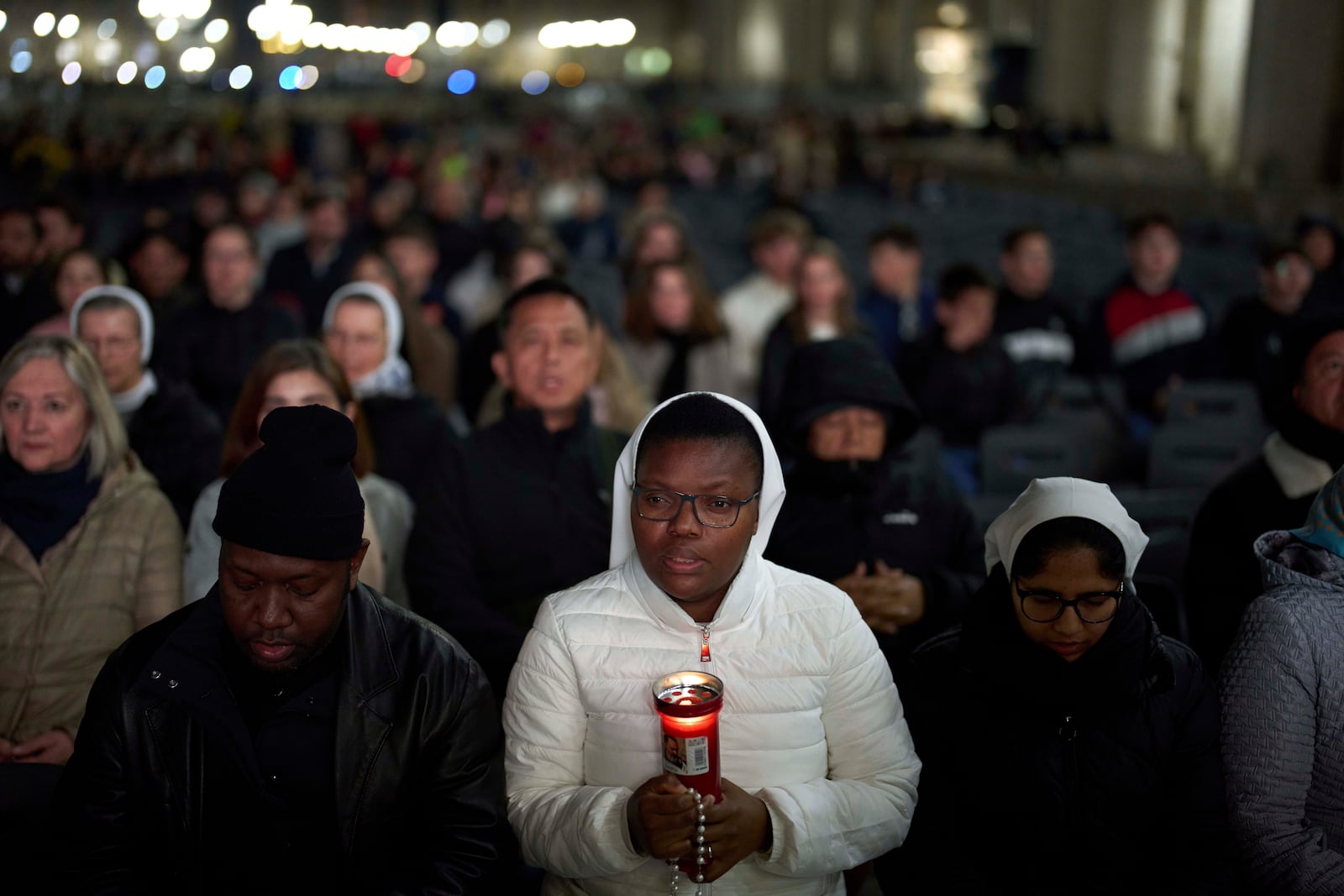 Catholic worshippers pray during a prayer of the Rosary for Pope Francis in St. Peter's Square at The Vatican, Thursday, March 6, 2025. (AP Photo/Francisco Seco)