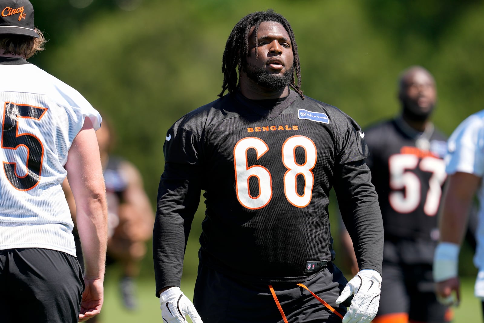 Cincinnati Bengals' McKinnley Jackson (68) stands with teammates during a NFL football practice, Tuesday, May 28, 2024, in Cincinnati. (AP Photo/Jeff Dean)