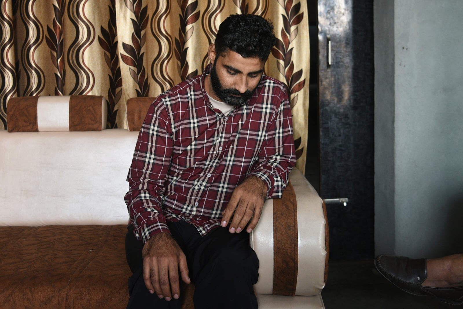 Jaspal Singh, 36, one of the Indian immigrants deported by the United States talks to his relatives upon his return to his home near Amritsar, India, Feb. 6, 2025. (AP Photo/Prabhjot Gill, File