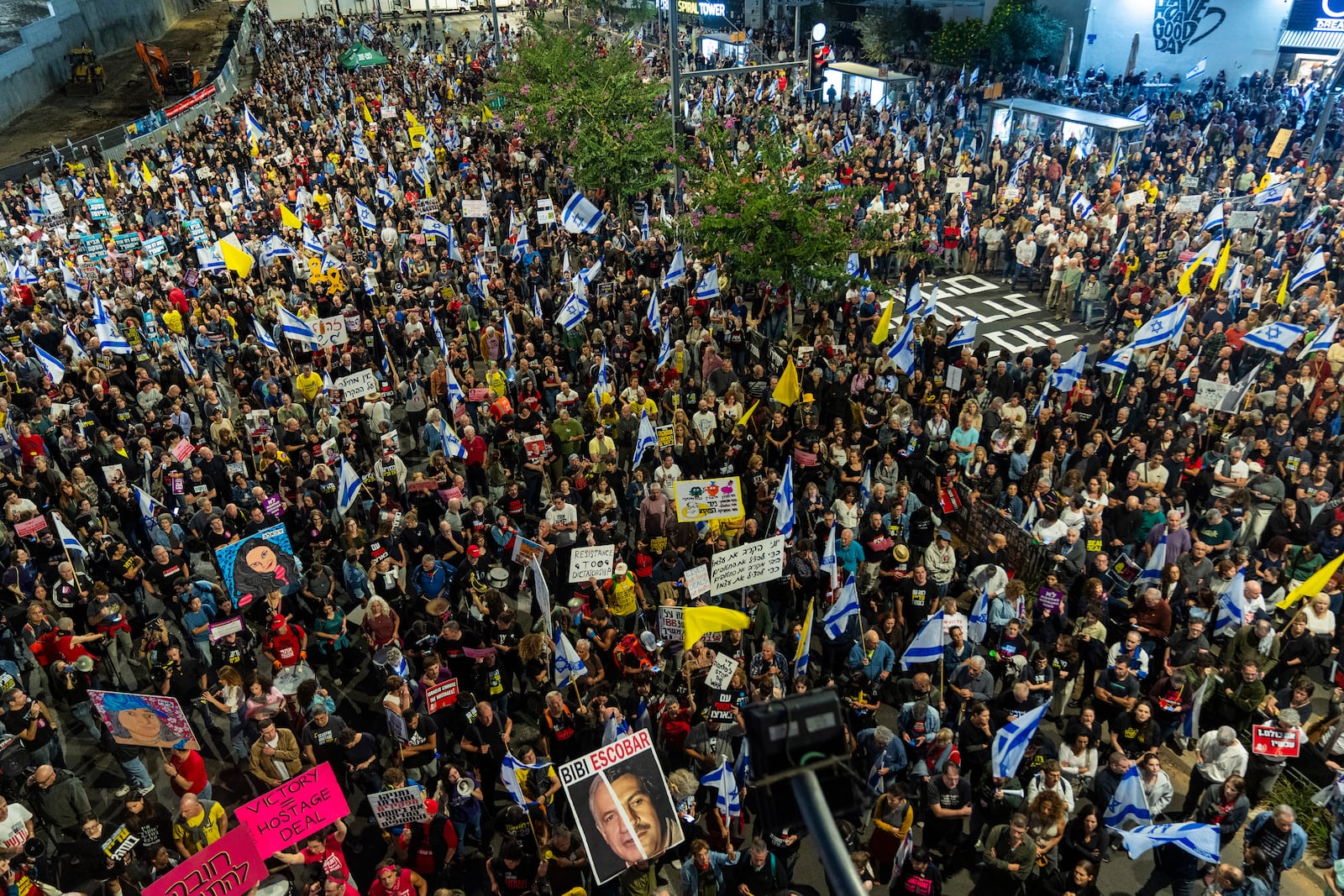 People gather to protest against Prime Minister Benjamin Netanyahu's government and call for the release of hostages held in the Gaza Strip by the Hamas militant group, in Tel Aviv, Israel, Saturday, Nov. 16, 2024. (AP Photo/Francisco Seco)