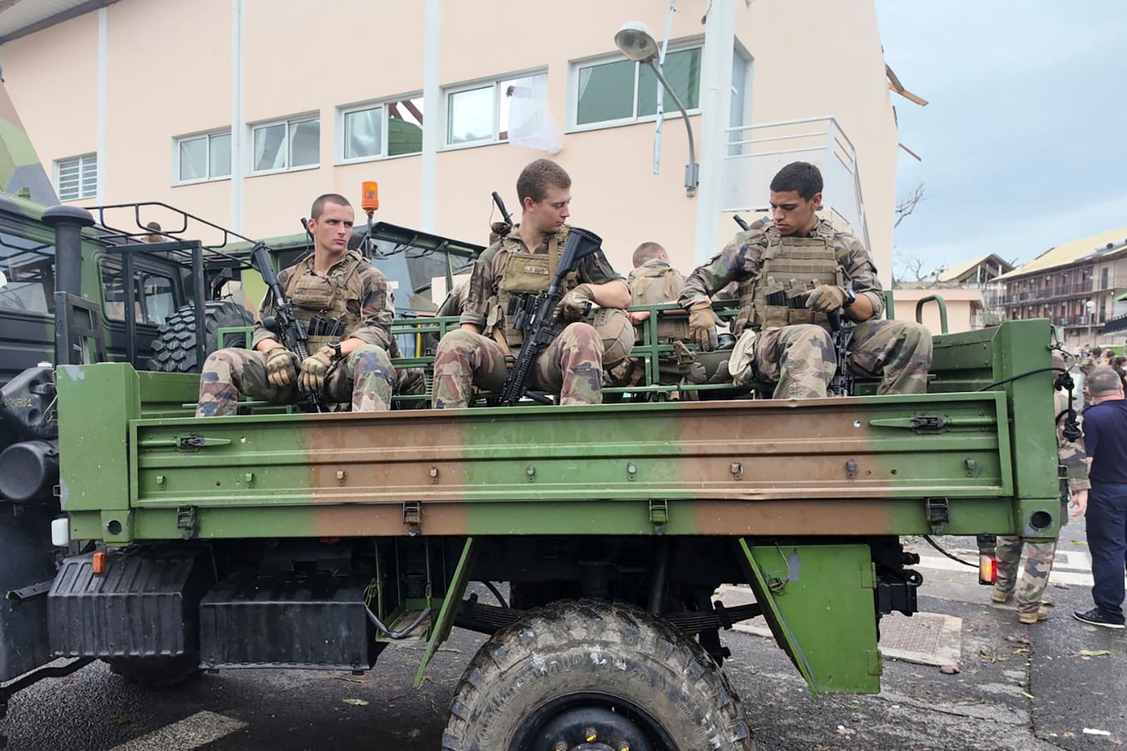 This photo provided Sunday Dec.15, 2024 by the French Army shows soldiers patrolling in a military truck in the French territory of Mayotte in the Indian Ocean, after Cyclone Chido caused extensive damage with reports of several fatalities. (Etat Major des Armées via AP)