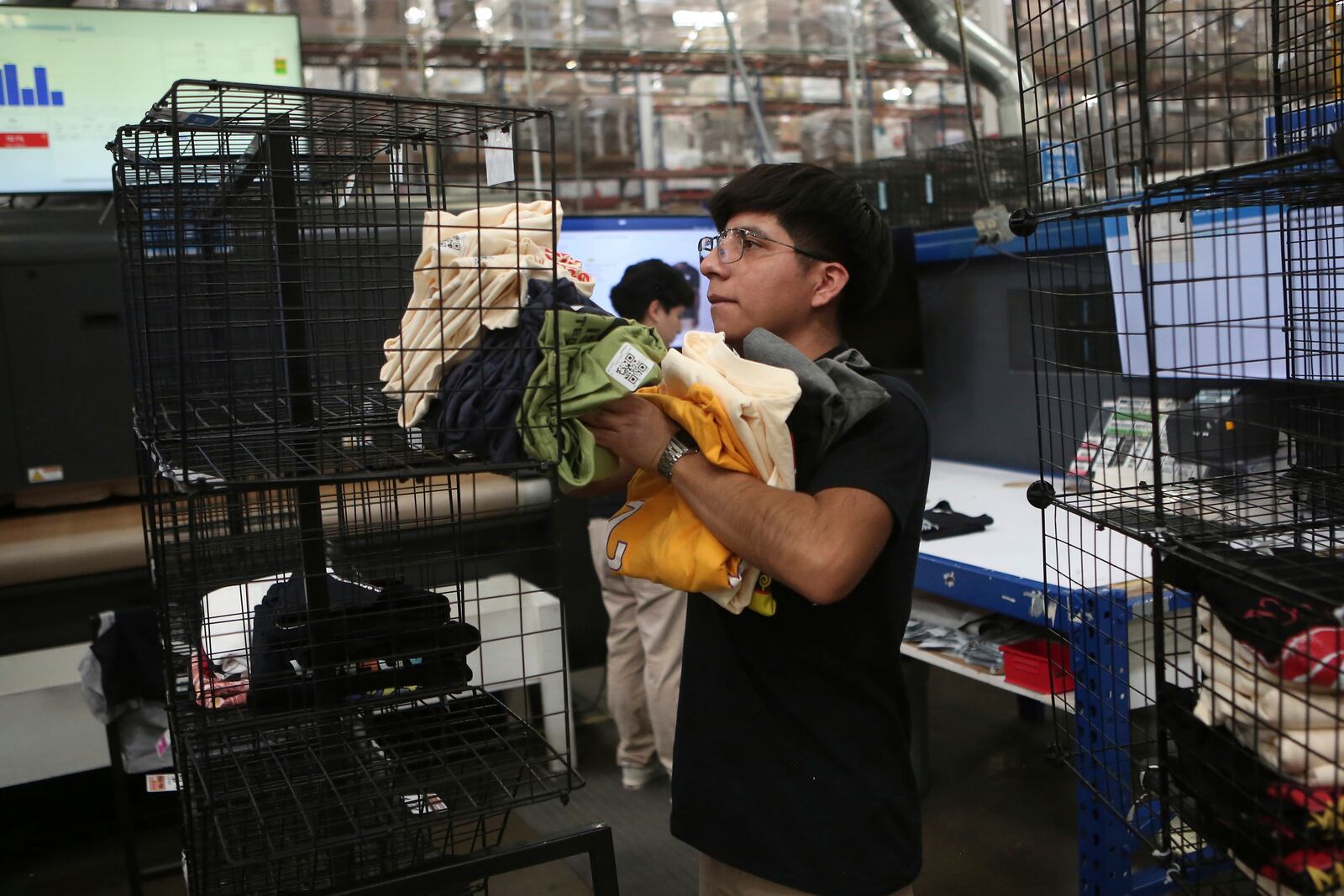 An employee works at a textile factory that produces T-shirts, in Ciudad Juarez, Mexico, Tuesday, Feb. 4, 2025. (AP Photo/Christian Chavez)