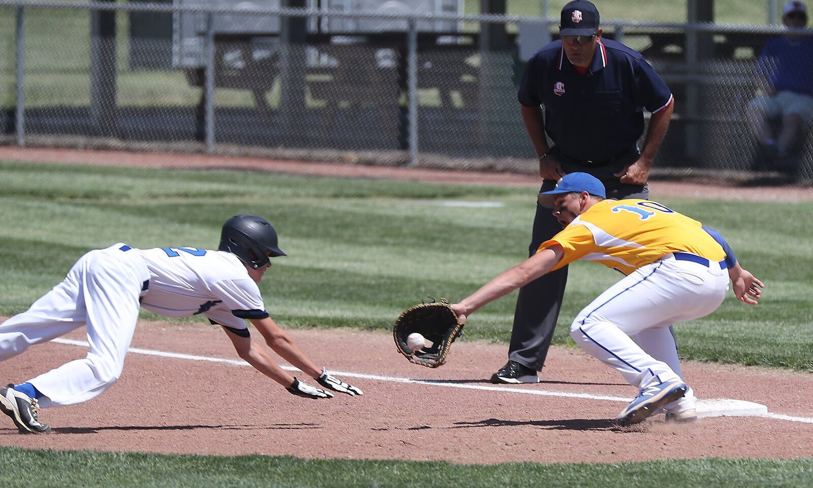 Russia’s Carter Francis picks off Cincinnati Christian’s Tim Carangi at first base during Thursday’s Division IV regional semifinal at Carleton Davidson Stadium in Springfield. BILL LACKEY/STAFF