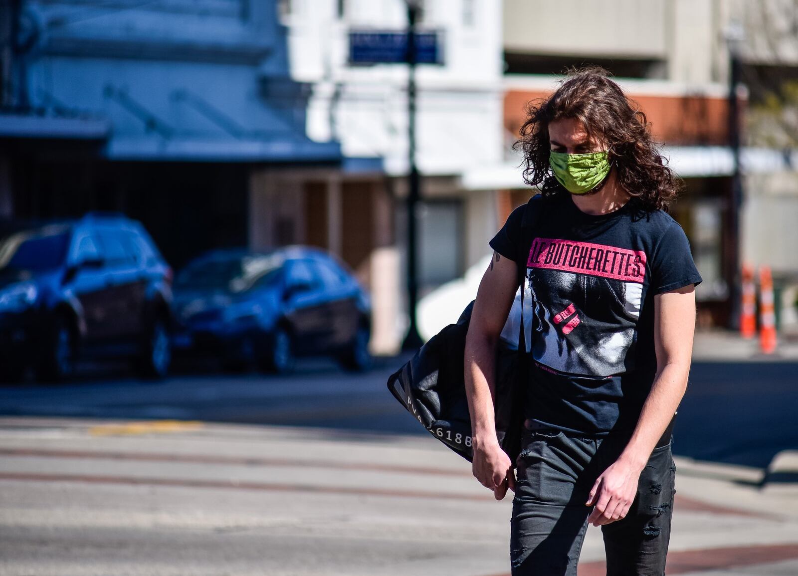 Mark Boyle wears a mask as he makes a food delivery for All8Up in downtown Hamilton Friday, April 3. NICK GRAHAM/STAFF