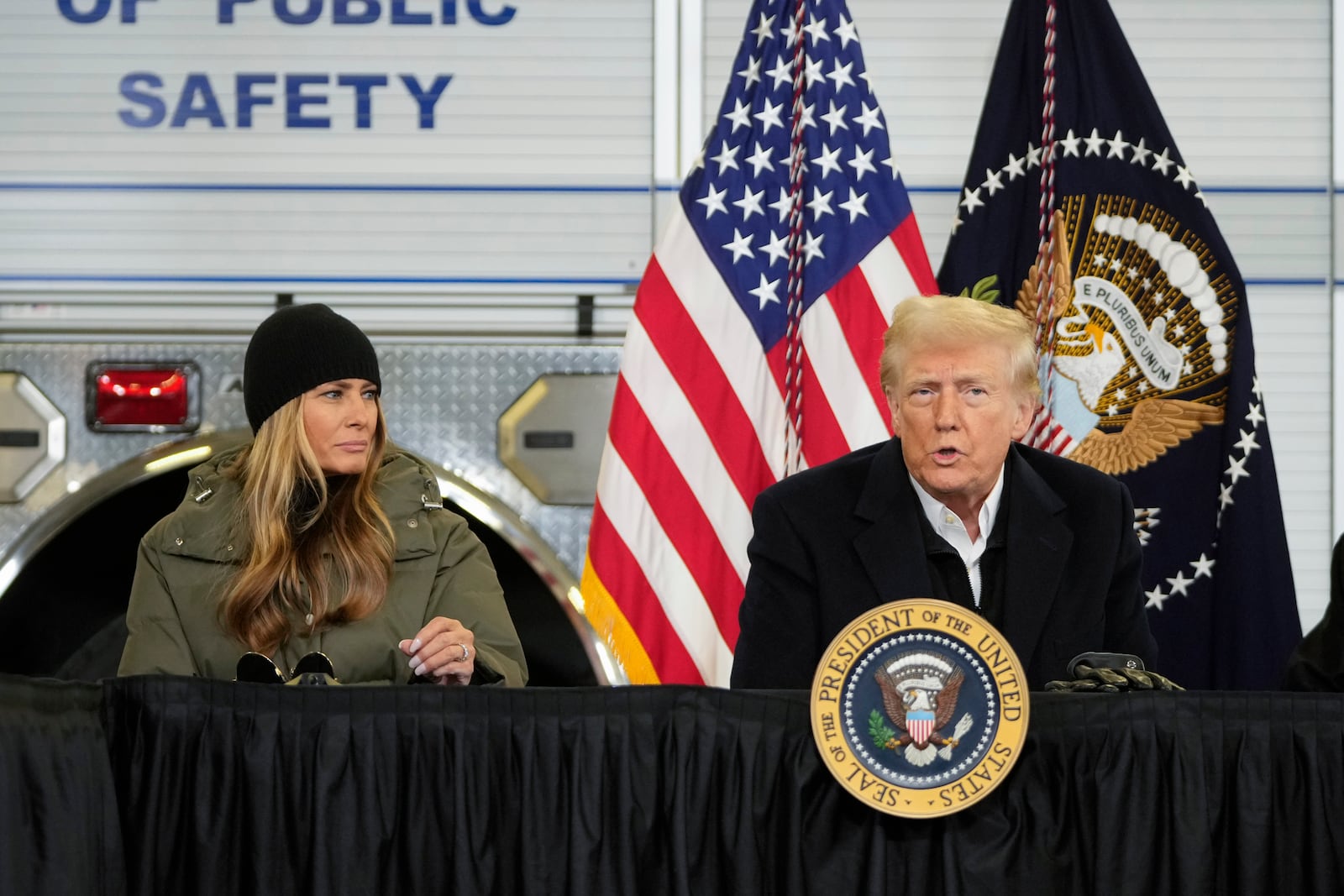 President Donald Trump is briefed on the effects of Hurricane Helene at Asheville Regional Airport in Fletcher, N.C., Friday, Jan. 24, 2025, as first lady Melania Trump looks on. (AP Photo/Mark Schiefelbein)