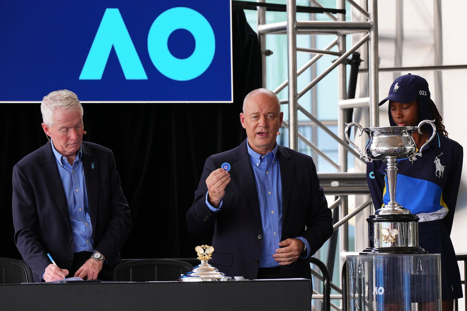 Tournament director Craig Tiley, left, and tournament referee Wayne McKewen conduct the official draw ahead of the Australian Open tennis championship in Melbourne, Australia, Thursday, Jan. 9, 2025. (AP Photo/Vincent Thian)