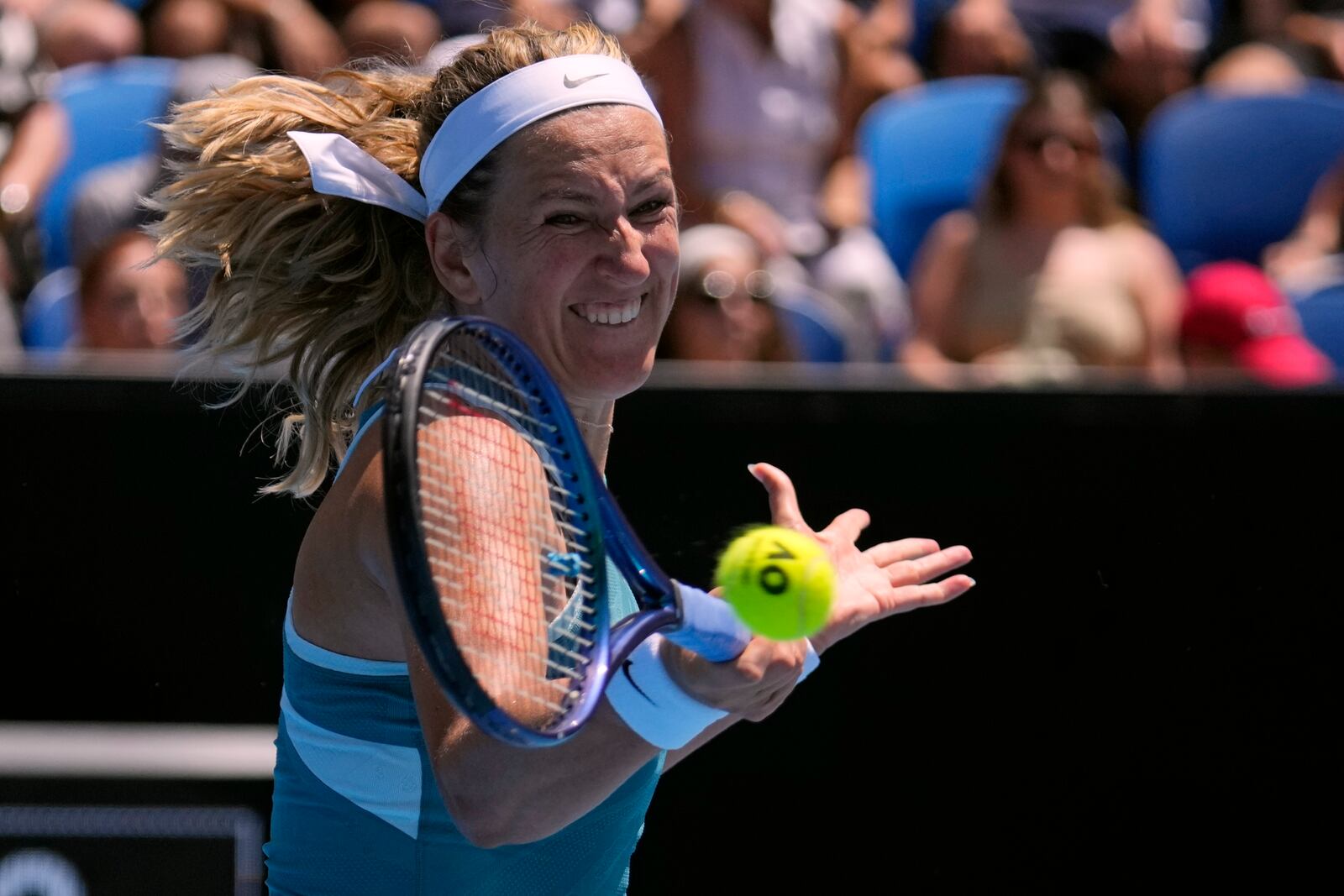 Victoria Azarenka of Belarus plays a forehand return to Lucia Bronzetti of Italy during their first round match at the Australian Open tennis championship in Melbourne, Australia, Monday, Jan. 13, 2025. (AP Photo/Vincent Thian)