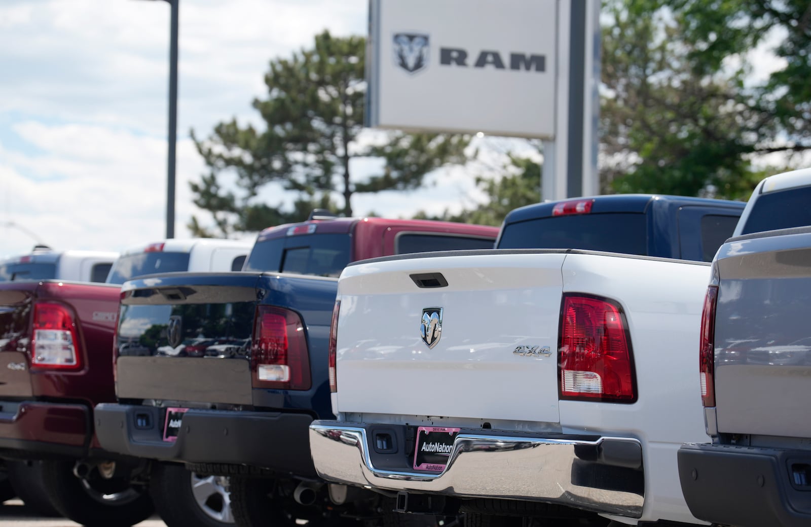 FILE - Unsold 2023 pickup trucks sit in a long row at a Ram dealership June 18, 2023, in Littleton, Colo. (AP Photo/David Zalubowski, File)