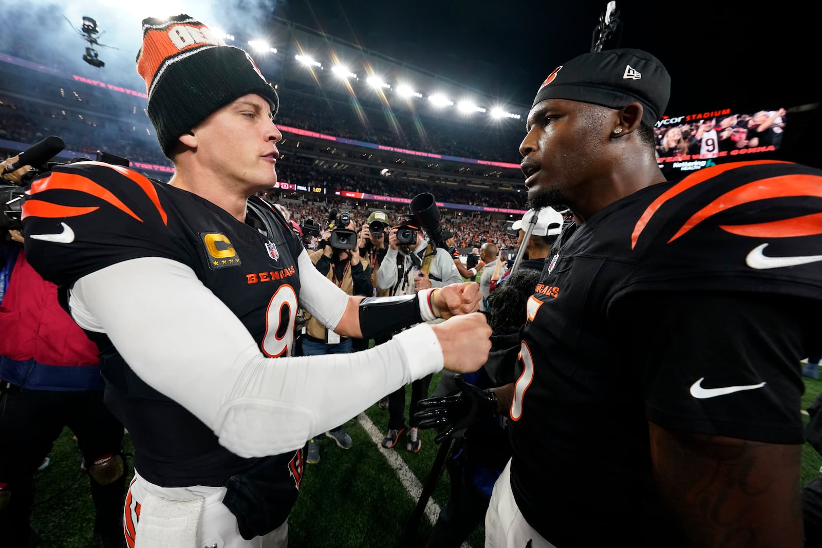 Cincinnati Bengals quarterback Joe Burrow (9) celebrates with wide receiver Tee Higgins (5) after an NFL football game against the Denver Broncos in Cincinnati, Saturday, Dec. 28, 2024. (AP Photo/Jeff Dean)