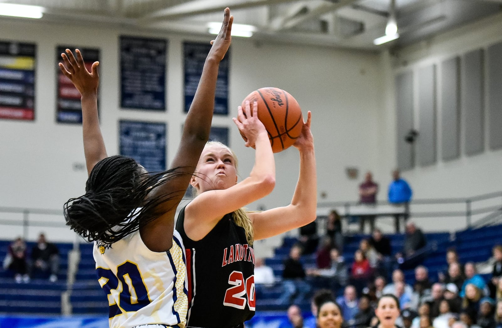 Lakota West’s Ally Haar puts up a shot while being defended by Walnut Hills’ Aniyah Brown on Wednesday night during a Division I regional semifinal at Fairmont’s Trent Arena. West advanced with a 60-31 win. NICK GRAHAM/STAFF