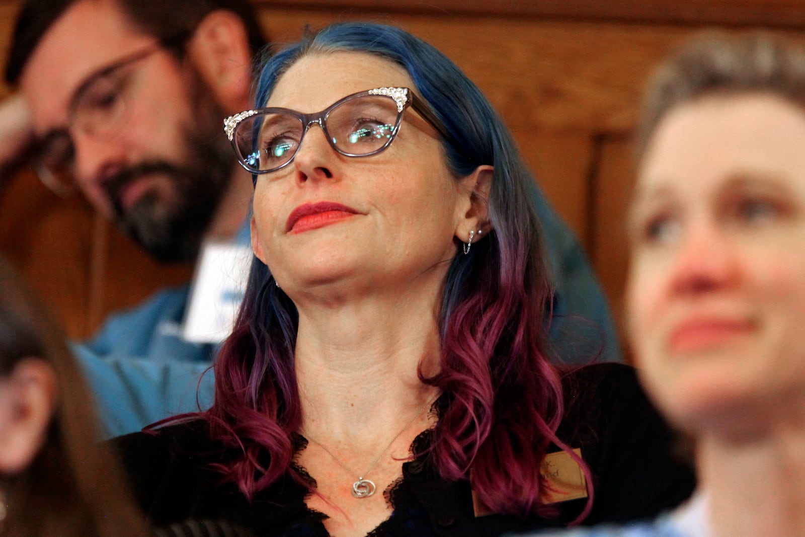 Elise Flatland, an Olathe, Kan., mother of two transgender children, watches a session of the Kansas Senate from one of its galleries, Wednesday, Jan. 29, 2025, at the Statehouse in Topeka, Kan. (AP Photo/John Hanna)