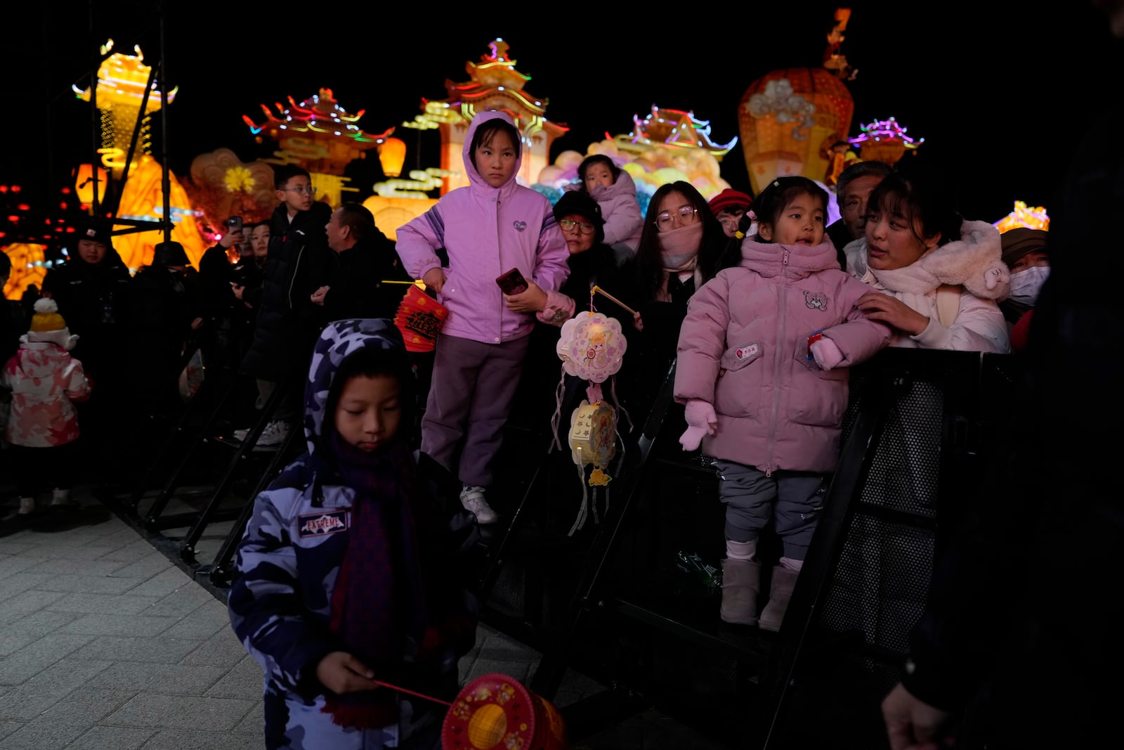 Visitors look at a show held for the Lantern Festival during Yuanxiao, the fifteen day of the Lunar New Year in Beijing, Wednesday, Feb. 12, 2025. (AP Photo/Ng Han Guan)