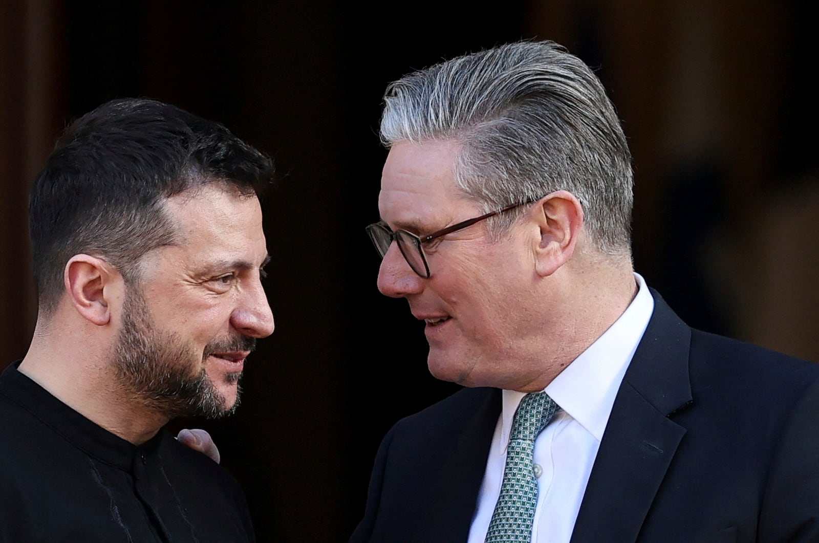 Britain's Prime Minister Keir Starmer, right, welcomes Ukrainian President Volodymyr Zelenskyy to the European leaders' summit to discuss Ukraine, at Lancaster House, London, Sunday March 2, 2025. (Toby Melville/Pool via AP)