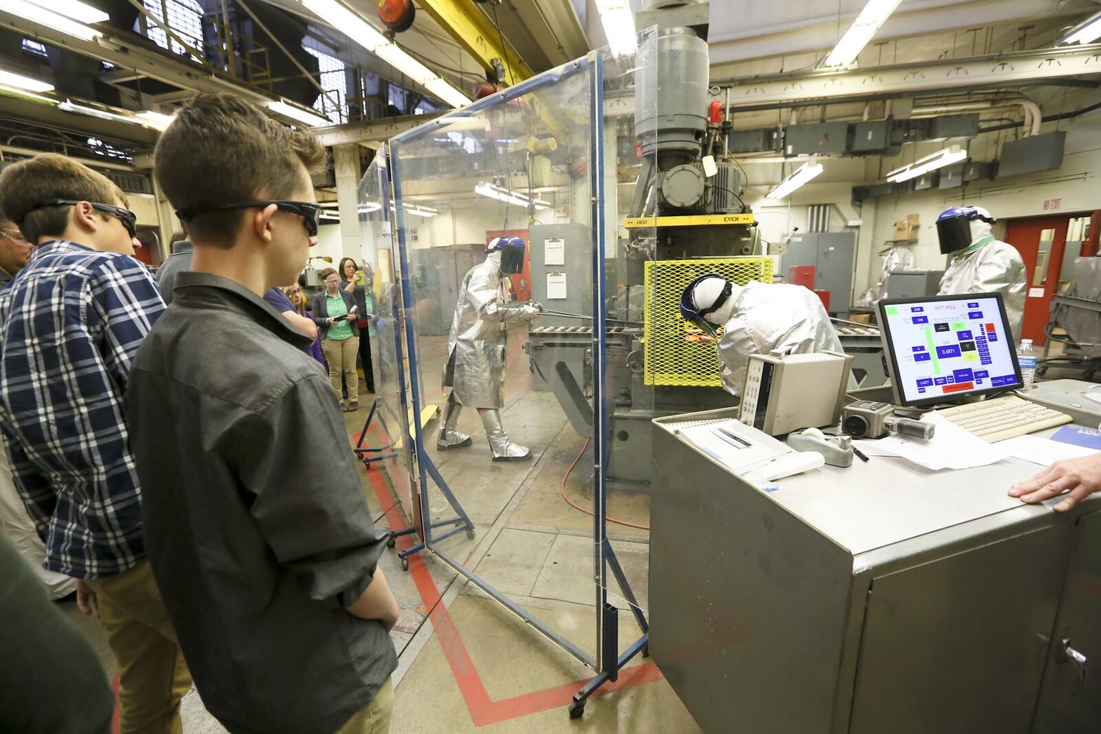 Students from Middletown and Monroe high schools listen to AK Steel research engineer Grant Thomas after viewing a hot rolling process demonstration as part of Manufacturing Day5. GREG LYNCH / STAFF