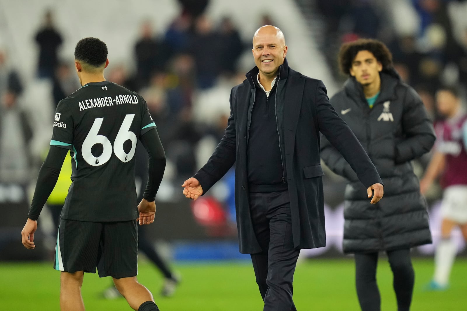 Liverpool's manager Arne Slot celebrates after their win in the English Premier League soccer match against West Ham United at the London Stadium in London, Monday, Dec. 30, 2024. (AP Photo/Kirsty Wigglesworth)