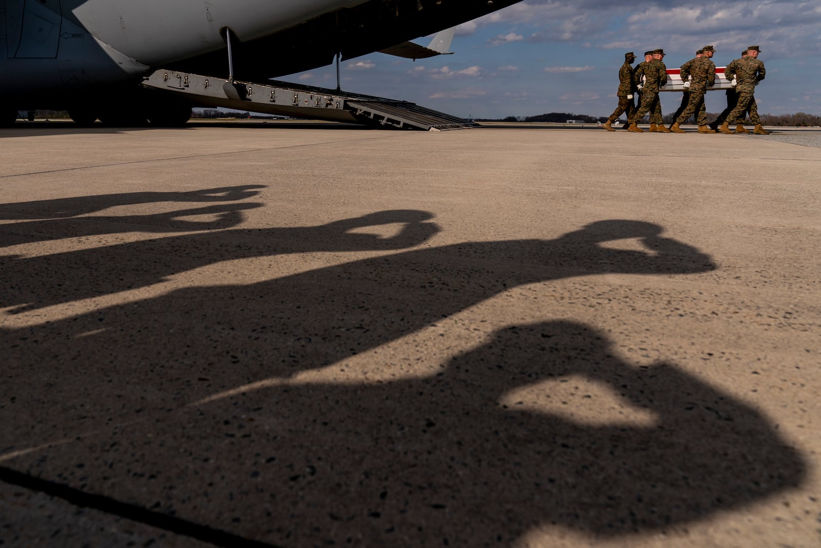 FILE - A U.S. Marine Corps carry team moves a transfer case containing the remains of Gunnery Sgt. James W. Speedy of Cambridge, Ohio, during a casualty return, Friday, March 25, 2022, at Dover Air Force Base. According to the Department of Defense, Speedy died March 18, in an Osprey crash during a NATO exercise in Norway. (AP Photo/Andrew Harnik)