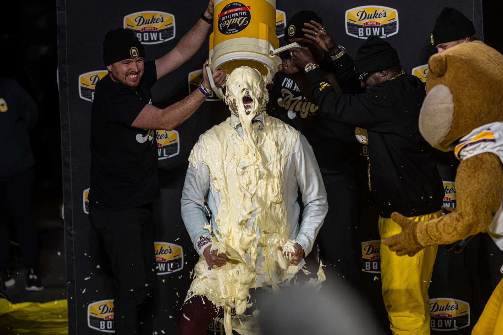 Minnesota head coach P.J. Fleck, center, receives the mayo dump after winning the Duke's Mayo Bowl NCAA college football game against Virginia Tech, Friday, Jan. 3, 2025, in Charlotte, N.C. (AP Photo/Robert Simmons)