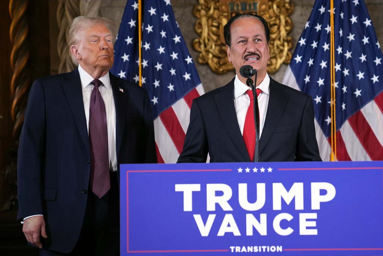 President-elect Donald Trump listens as Hussain Sajwani, CEO of DAMAC Properties, speaks during a news conference at Mar-a-Lago, Tuesday, Jan. 7, 2024, in Palm Beach, Fla. (AP Photo/Evan Vucci)