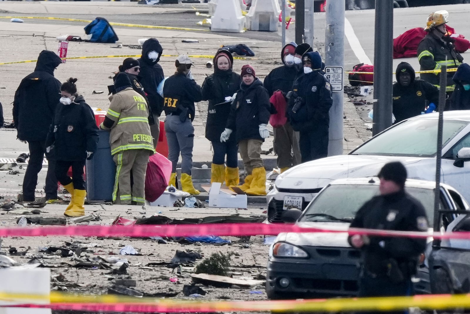 Investigators work the scene after a small plane crashed in Philadelphia, Saturday, Feb. 1, 2025. (AP Photo/Matt Rourke)