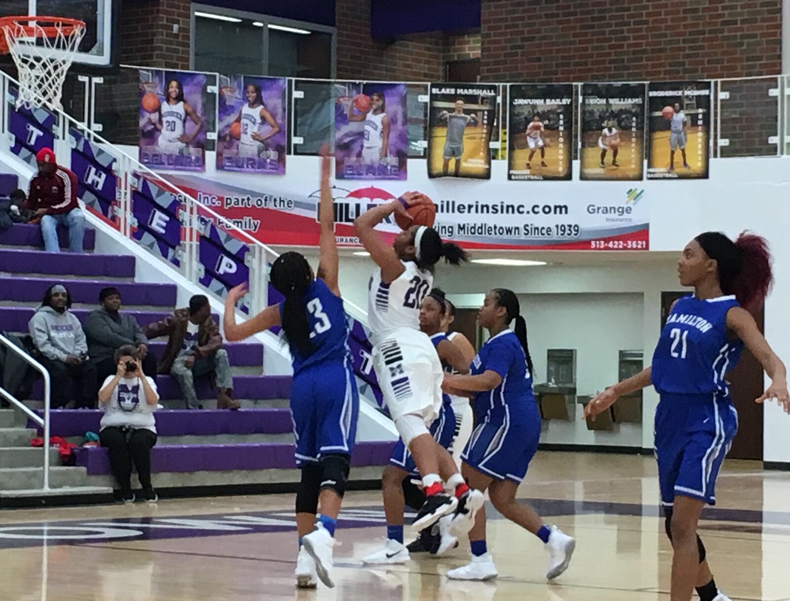 Middletown’s Aubriana Bellard (20) puts up a shot between Hamilton’s Makayla Rogers and Kira Ash on Saturday afternoon at Wade E. Miller Arena in Middletown. RICK CASSANO/STAFF