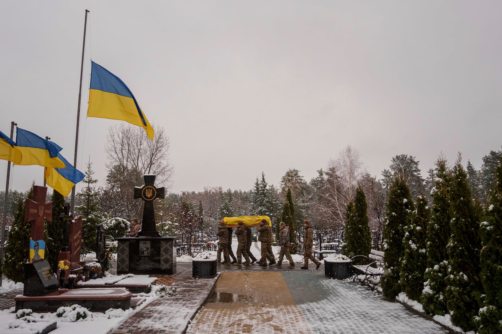 Honor Guards carry the coffin of fallen Ukrainian serviceman of the 47th brigade Serhii Solovyov, who was killed during fighting with Russian Forces in Kursk oblast on November 12, during the funeral ceremony in Irpin, Kyiv region, Ukraine, Nov. 21, 2024. (AP Photo/Evgeniy Maloletka)