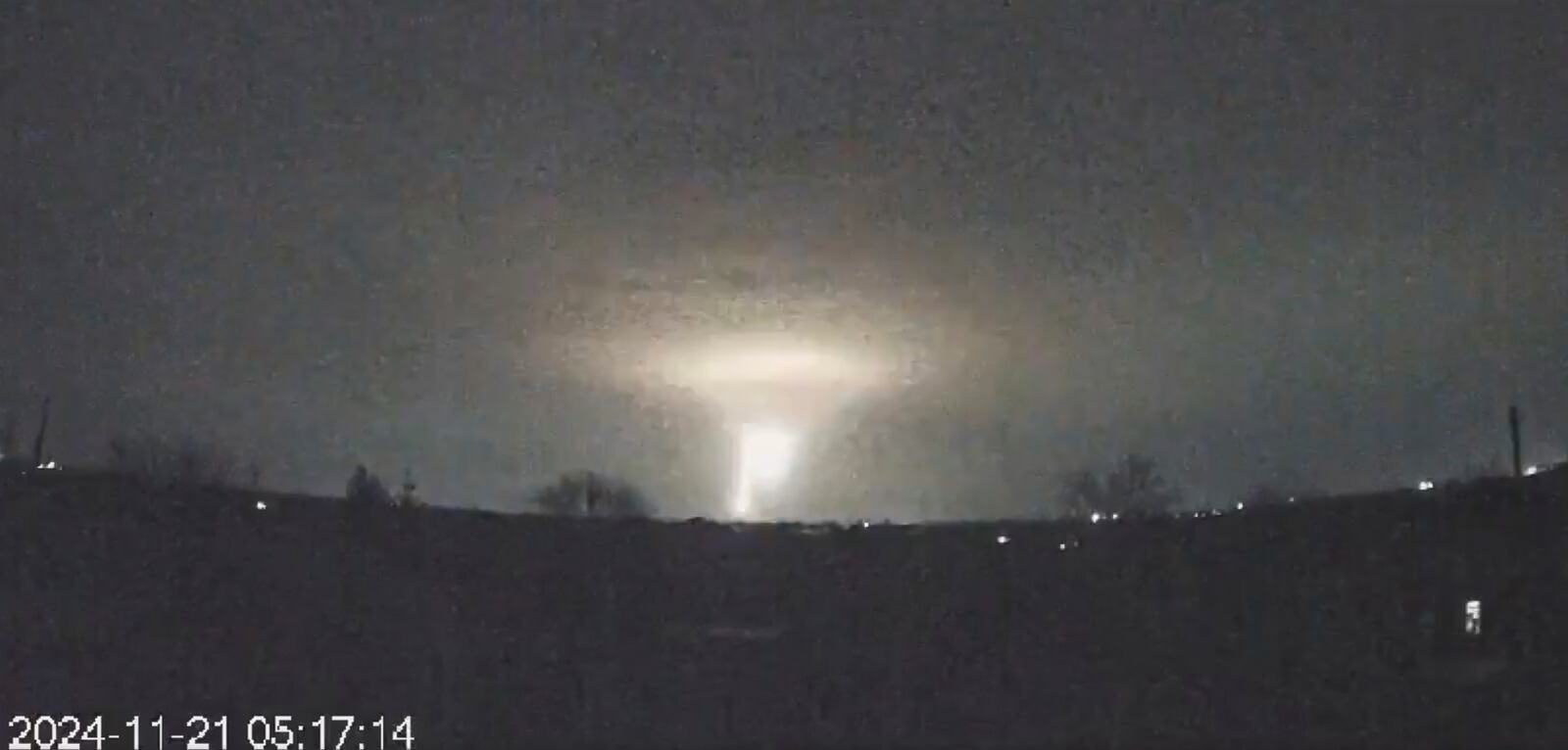 In this screen grab from a video provided by the Come Back Alive Foundation on Nov. 21, 2024, lights are seen in the sky during a Russian attack on Dnipro, Ukraine. (Ukrainian Emergency Service via AP)