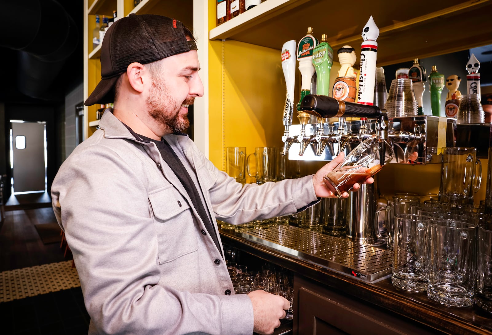 General Manager Mat Wells pours a Guinness at The Lucky Well Irish Pub & Eatery now open next to The Well House hotel in Hamilton. NICK GRAHAM/STAFF