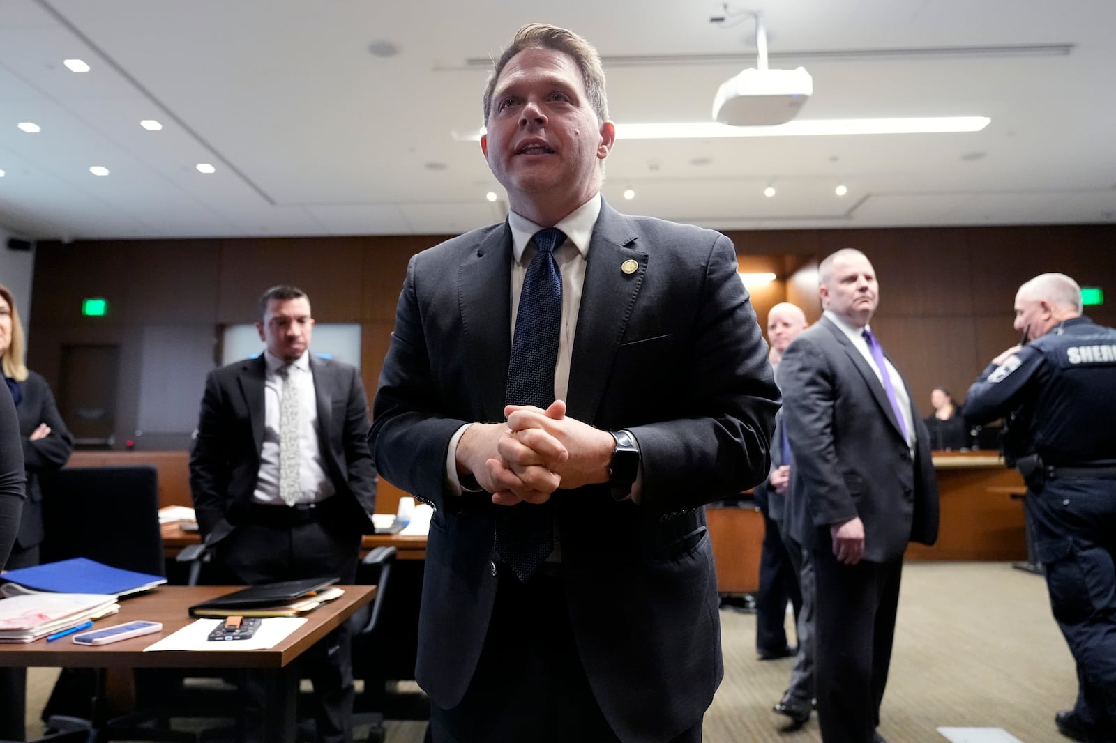 Lake County, Ill., State's Attorney Eric Rinehart talks to victim's families after Robert E. Crimo III, left after pleading guilty to the Highland Park parade shooting in Judge Victoria A. Rossetti's courtroom in Waukegan, Ill., Monday, March 3, 2025. (AP Photo/Nam Y. Huh, Pool)