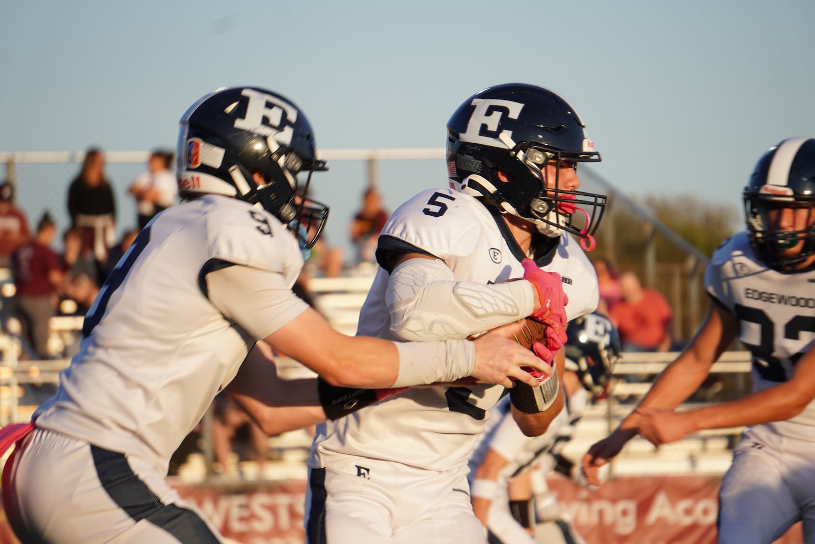 Edgewood quarterback Carter Breedlove (9) hands the ball off to Brody O'Banion during their game against Ross on Friday night at Robinson Field. Chris Vogt/CONTRIBUTED