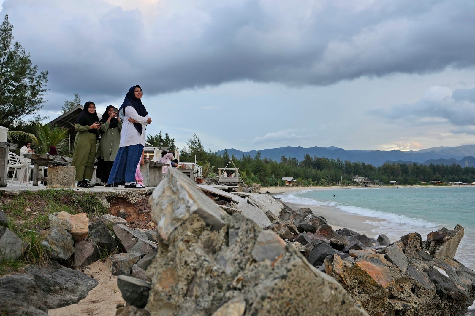 Young girls enjoy the view at Lampuuk beach, one of the areas hardest hit by Indian Ocean tsunami in 2004, on the outskirts of Banda Aceh, Indonesia, Friday, Dec. 13, 2024. (AP Photo/Achmad Ibrahim)