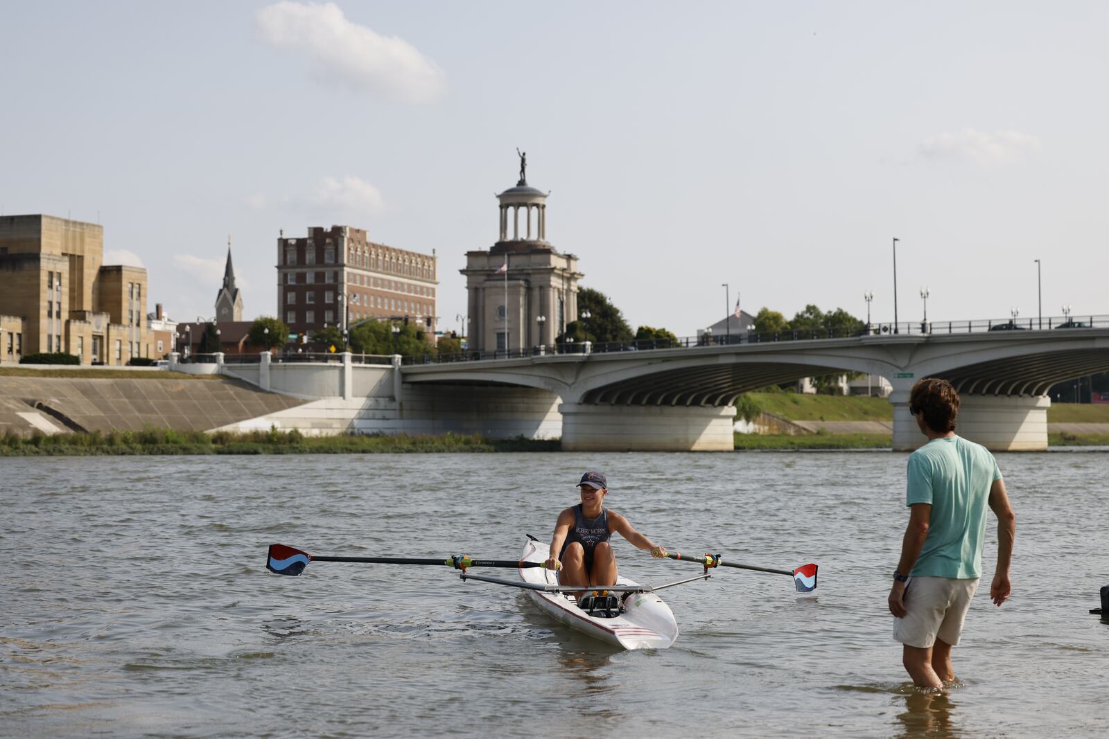 Marc Oria, head coach of Great Miami Crew, communicates with rower Cassidy Norton during practice Wednesday, Aug. 11, 2021 on the Great Miami River in Hamilton. Oria, Norton and a few others will be travelling to Barcelona, Spain to train for a world competition in Portugal. Norton will compete as a single in the coastal rowing boat competition. NICK GRAHAM / STAFF