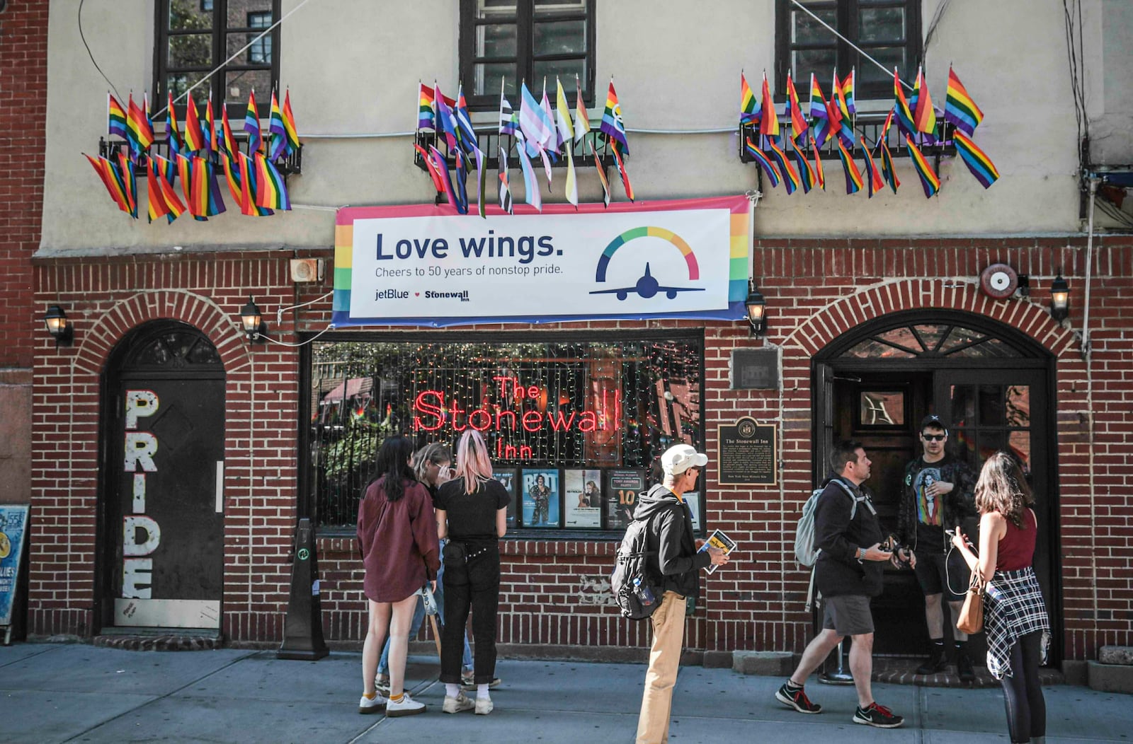 FILE - Pride flags and colors display on the Stonewall Inn bar, marking the site of 1969 riots that followed a police raid of the bar's gay patrons, June 3, 2019, in New York. (AP Photo/Bebeto Matthews, File)