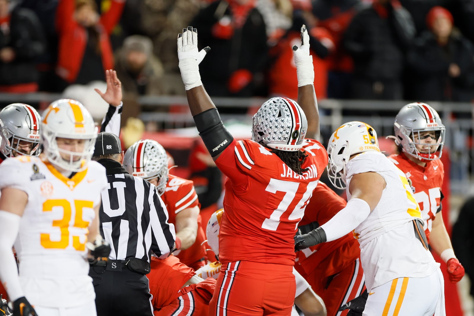 Ohio State offensive lineman Donovan Jackson, center, celebrates after a touchdown against Tennessee during the second half in the first round of the College Football Playoff, Saturday, Dec. 21, 2024, in Columbus, Ohio. (AP Photo/Jay LaPrete)