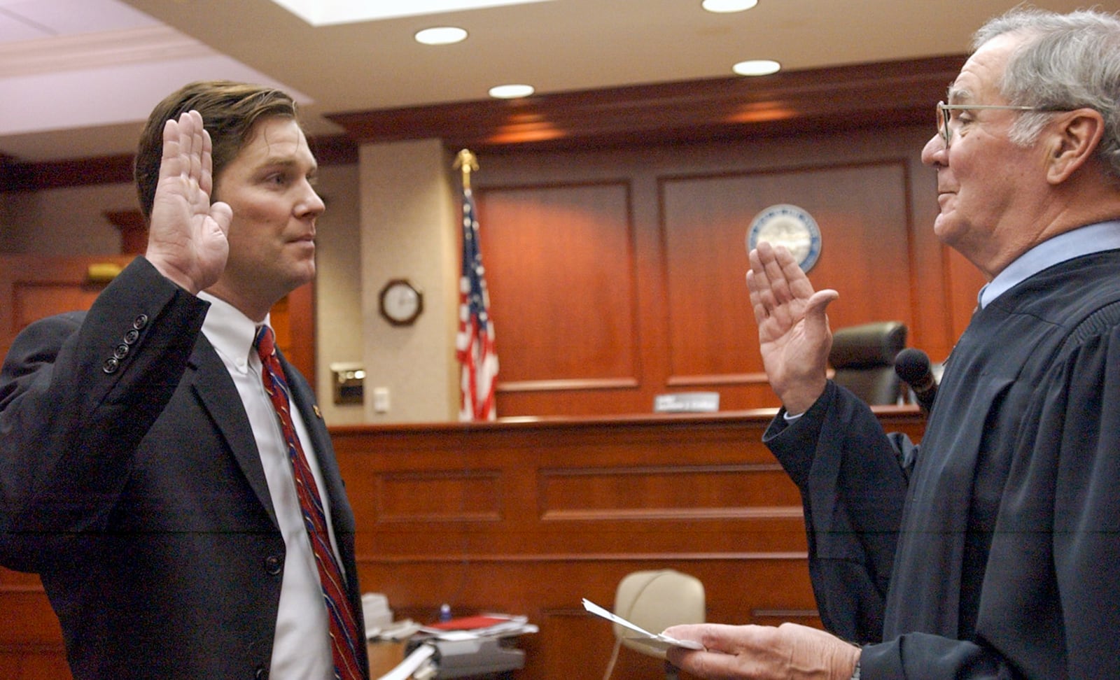 TONY TRIBBLE/JOURNALNEWS
Kenneth Crehan(left) is sworn in by his Father Judge Matthew Crehan. Kenneth Crehan has just passed the bar exam.