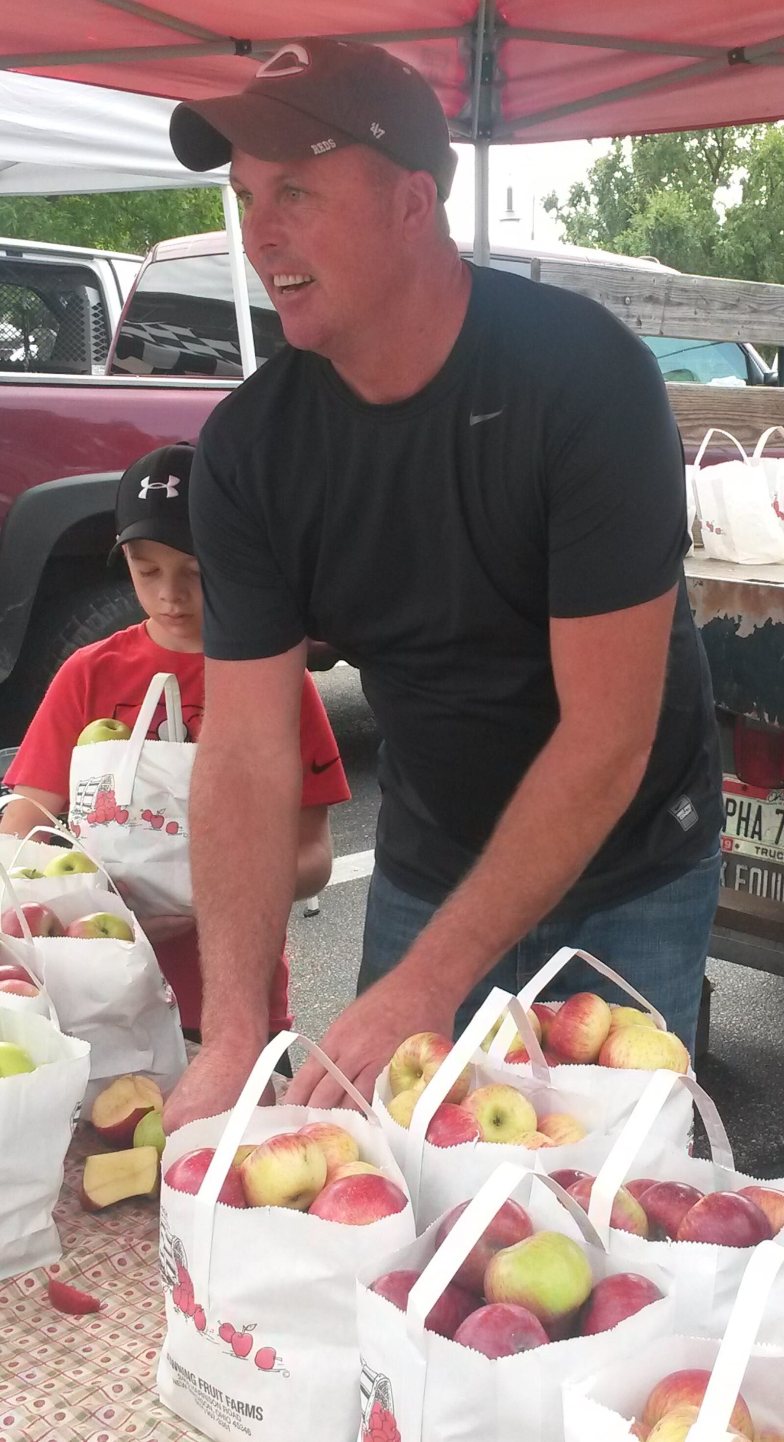 Scott Downing, of Downing Fruit Farm in New Madison, is seen selling apples at the Oxford Farmers Market. CONTRIBUTED