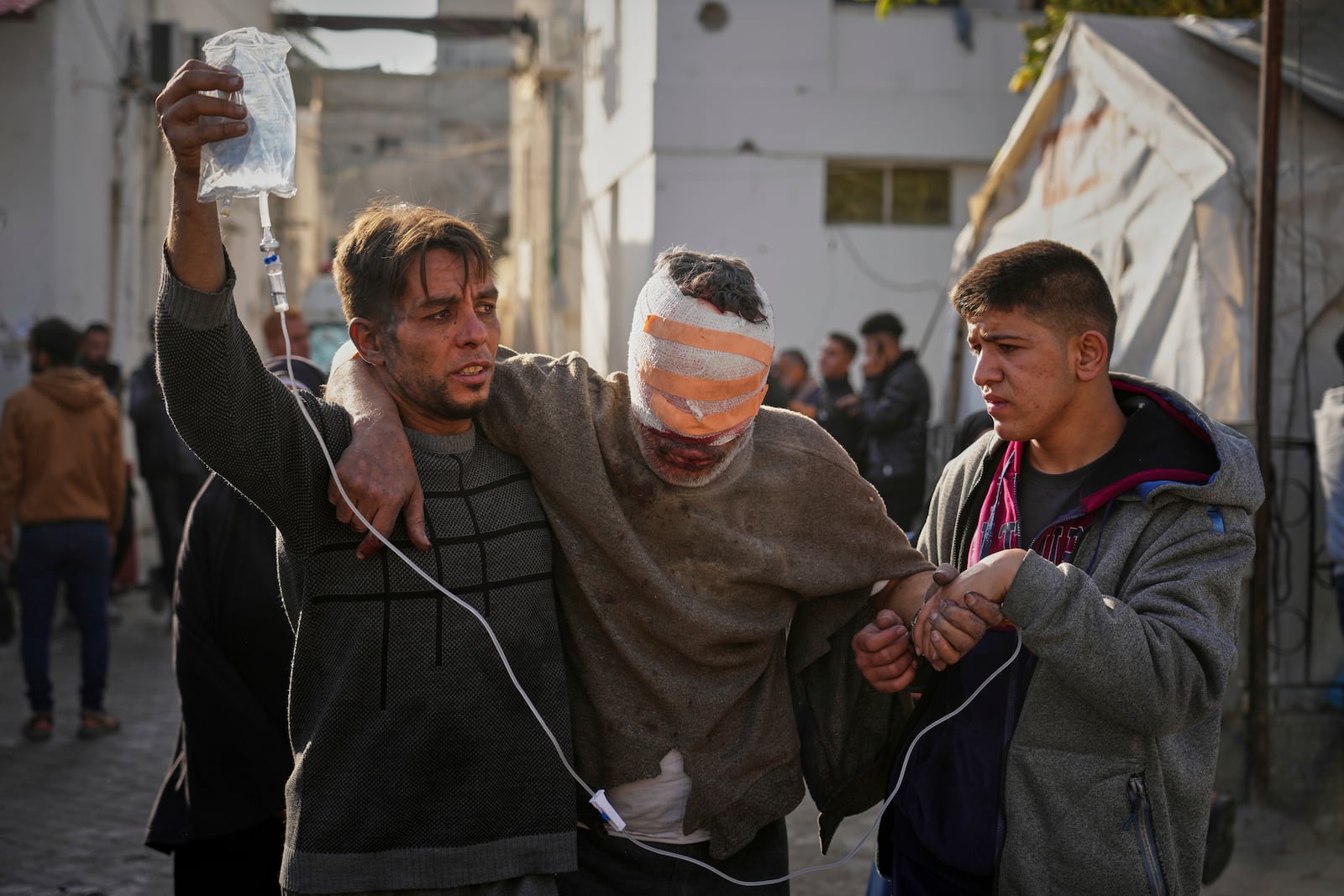 An injured man is take to the Al-Ahli hospital following Israeli army overnight airstrikes across the Gaza Strip, in Gaza City, Tuesday, March 18, 2025. (AP Photo/Jehad Alshrafi).