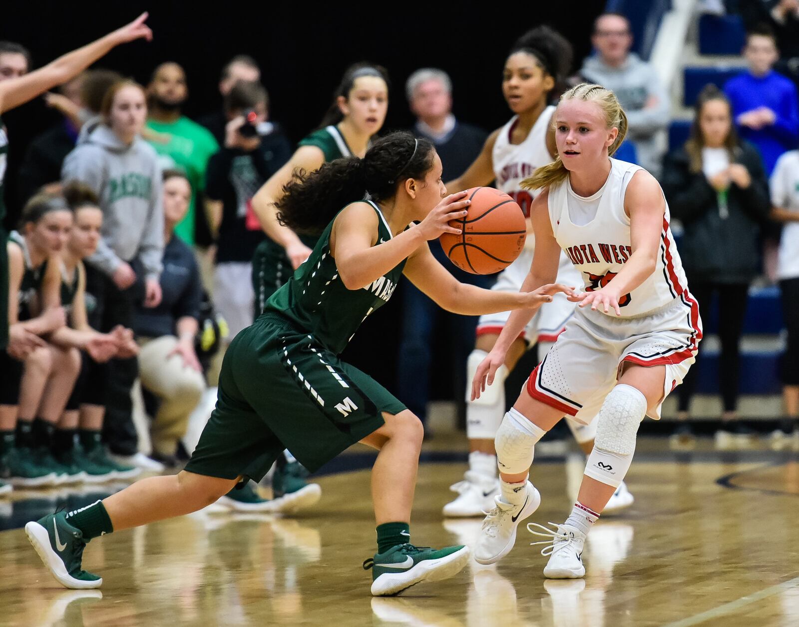 Mason's Sade Tucker tries to make a move on Lakota West’s Ally Haar during Saturday night’s Division I regional final at Fairmont’s Trent Arena. NICK GRAHAM/STAFF