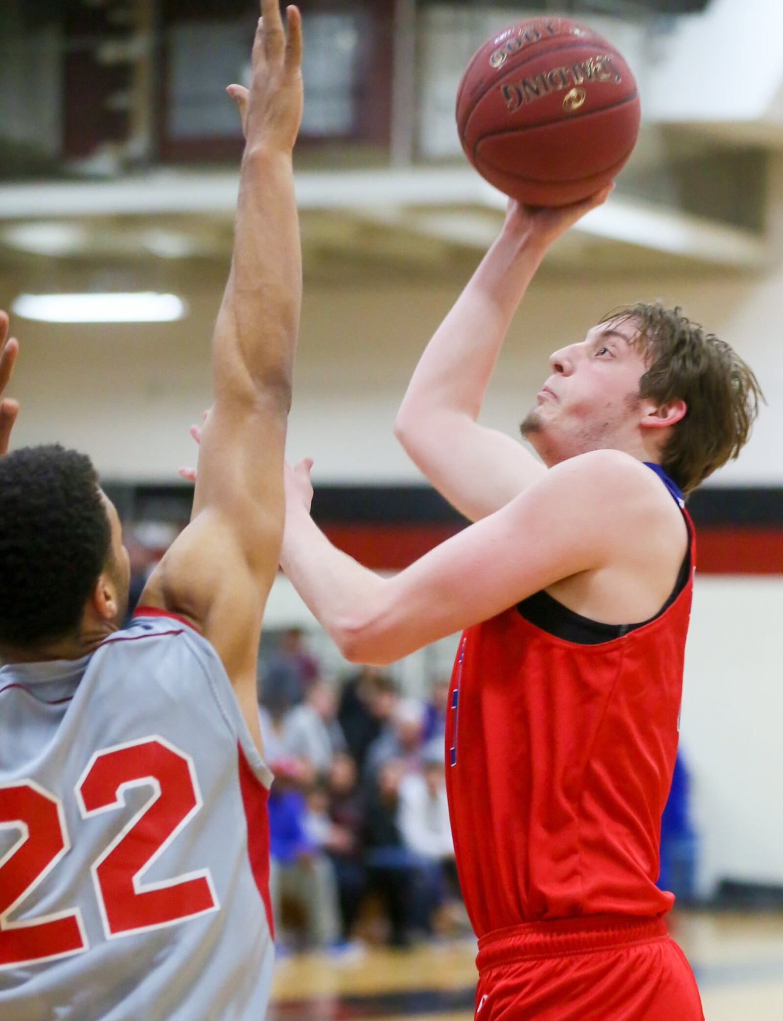 Miami Middletown forward Ryan Haeseker (33) takes a shot over Miami Hamilton’s Chris Edwards on Wednesday night at MUH. GREG LYNCH/STAFF