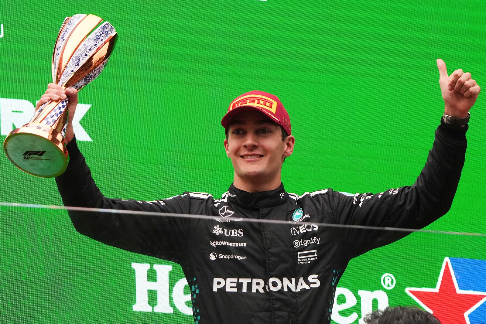 Mercedes driver George Russell of Britain celebrates on the podium after placing third in the Chinese Formula One Grand Prix race at the Shanghai International Circuit, Shanghai, Sunday, March 23, 2025. (AP Photo/Andy Wong)