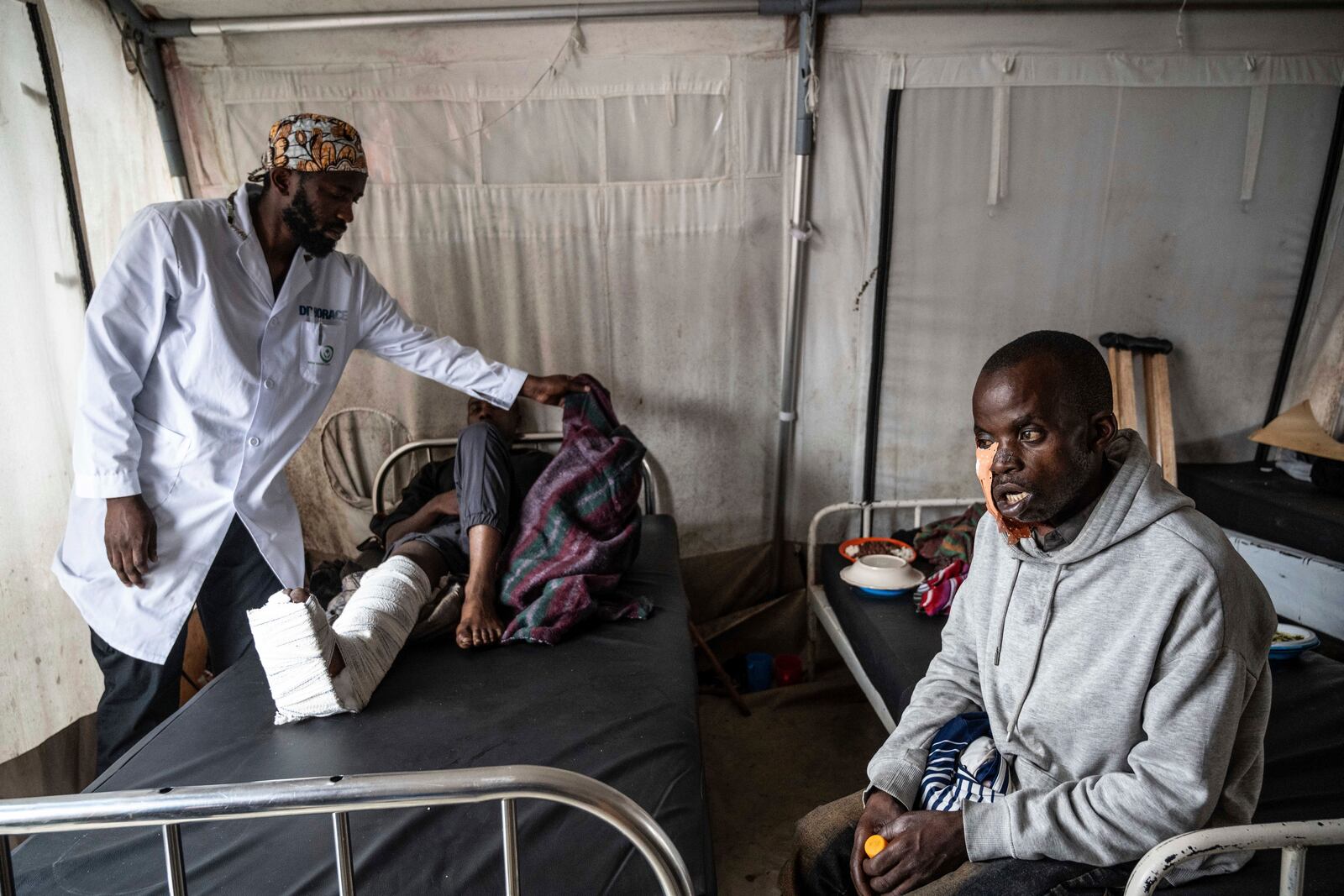 Medics treat a man wounded during fighting between Congolese government troops and M23 rebel forces in Goma's Kyeshero hospital Saturday, Feb. 1, 2025. (AP Photo/Moses Sawasawa)