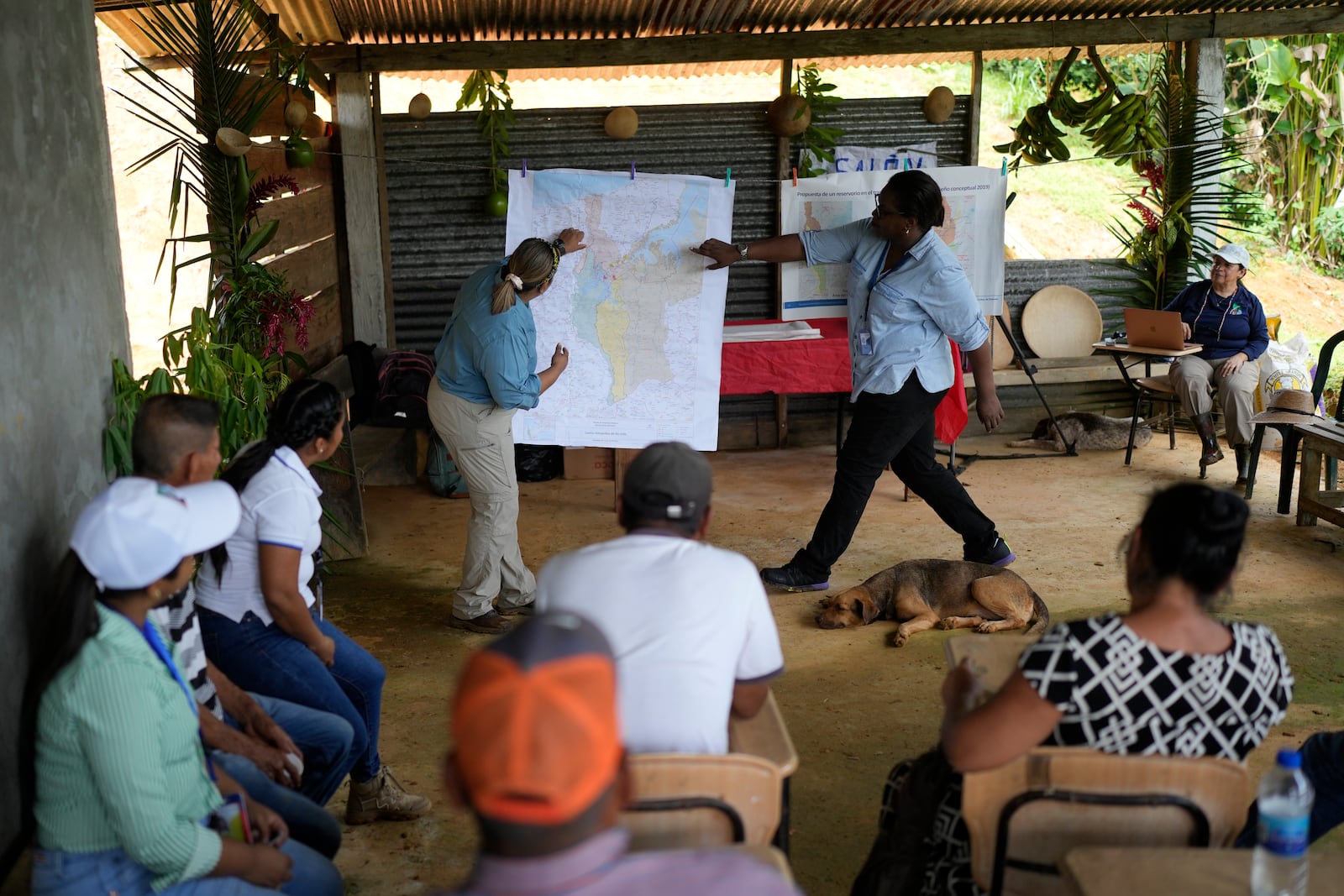 Panama Canal representatives explain to locals how a proposed dam project in the Indio River that aims to secure the canal's uninterrupted operation could affect the future of El Jobo, Panama, Saturday, Aug. 31, 2024. (AP Photo/Matias Delacroix)