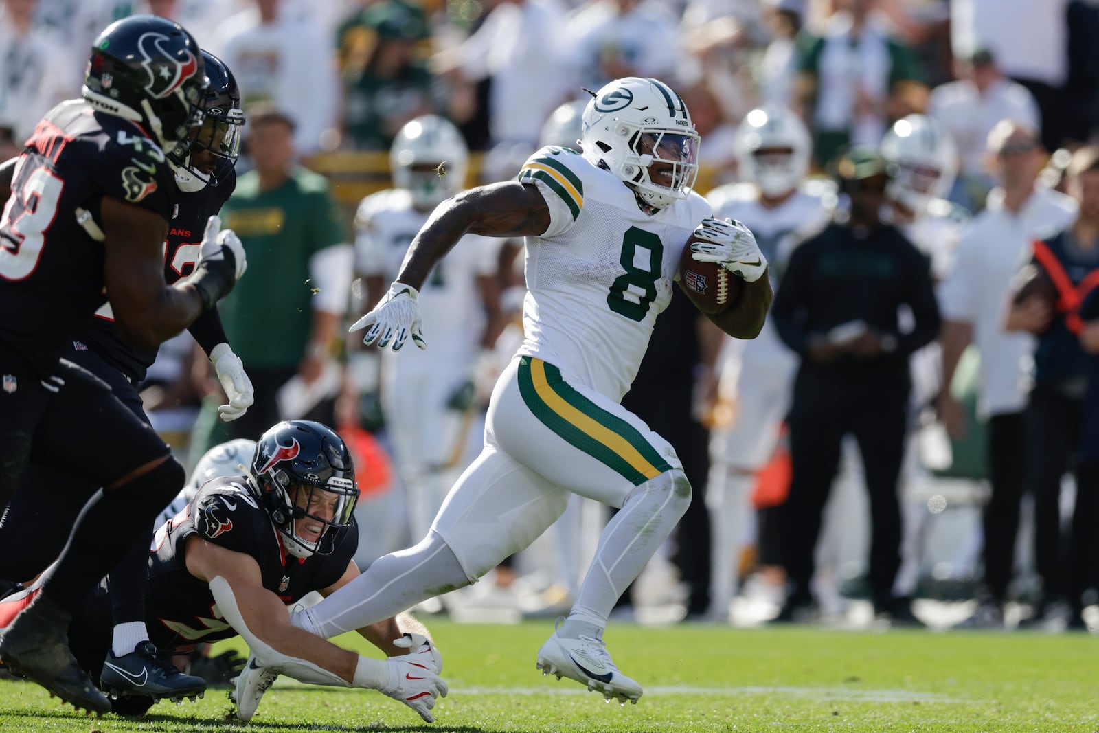 Green Bay Packers running back Josh Jacobs (8) rushes past Houston Texans linebacker Jake Hansen (35) for a first down during the second half of an NFL football game, Sunday, Oct. 20, 2024, in Green Bay, Wis. (AP Photo/Matt Ludtke)