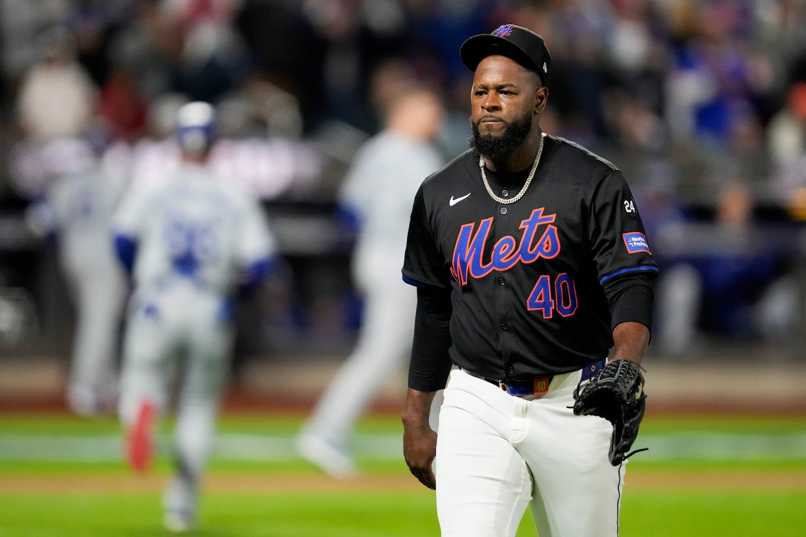 New York Mets pitcher Luis Severino walks to the dugout during the first inning in Game 3 of a baseball NL Championship Series against the Los Angeles Dodgers, Wednesday, Oct. 16, 2024, in New York. (AP Photo/Ashley Landis)